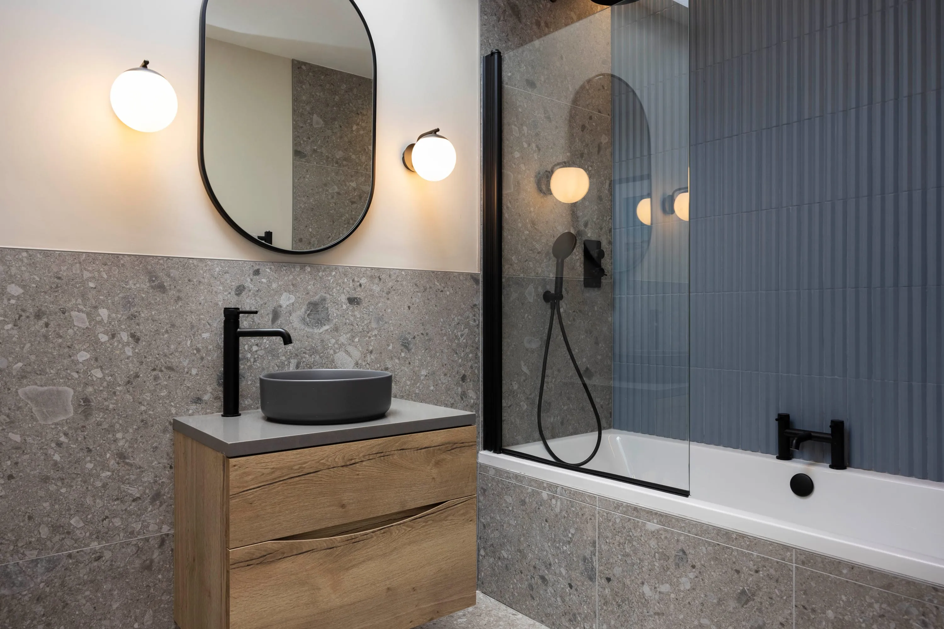 Family bathroom with terrazzo tiles, oak vanity and bath