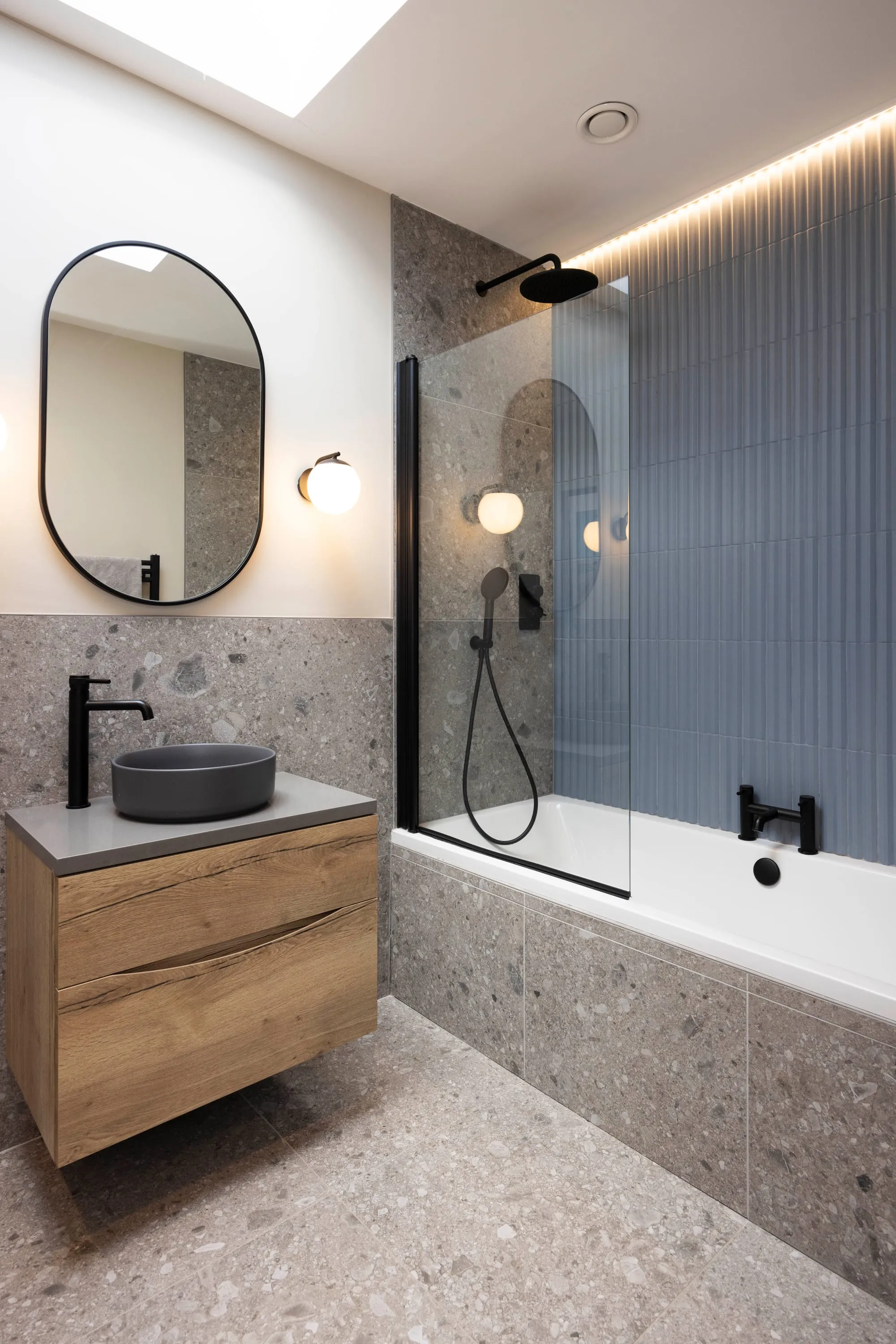 Family bathroom with oak vanity, terrazzo tiling and fluted shower screen
