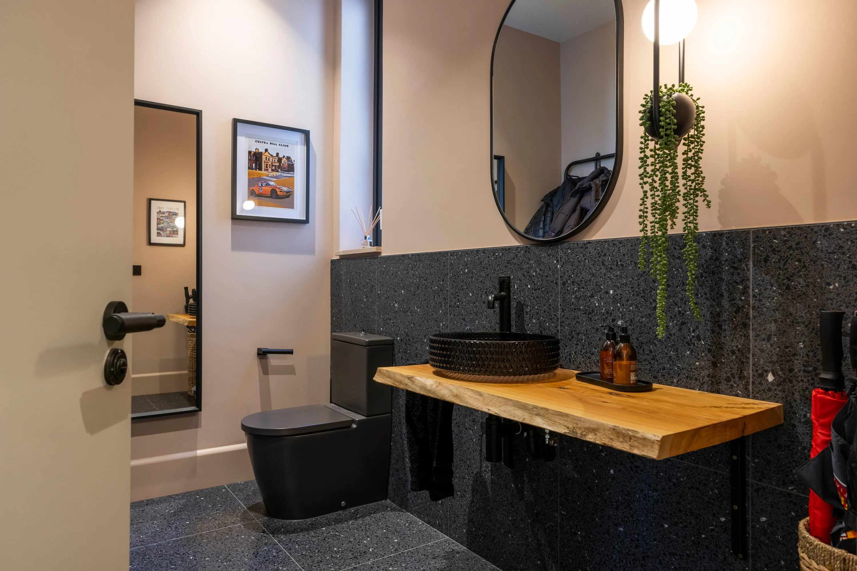 Cloakroom with live-edge oak basin shelf and terrazzo tiling
