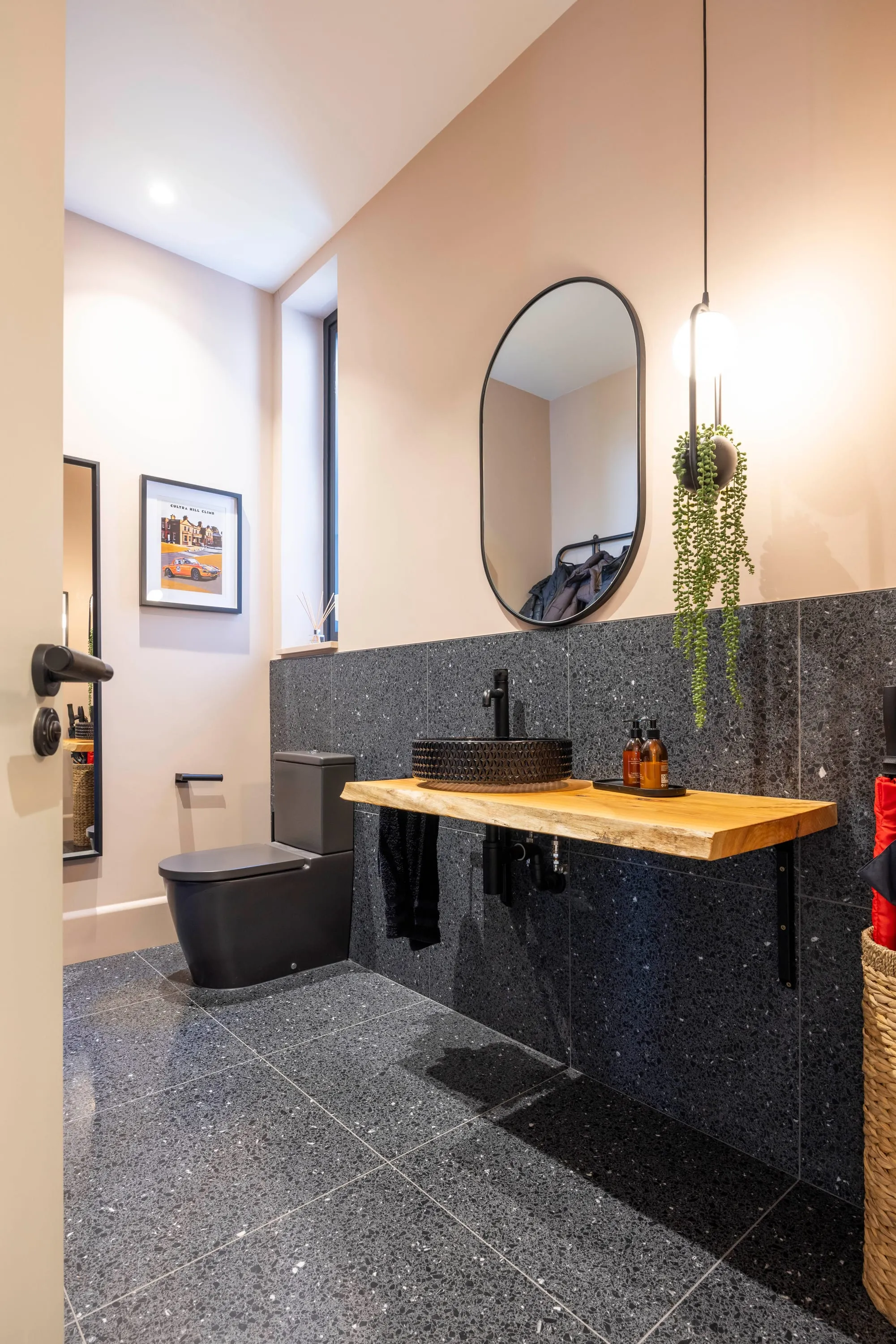 Cloakroom with oval mirror and pendant light