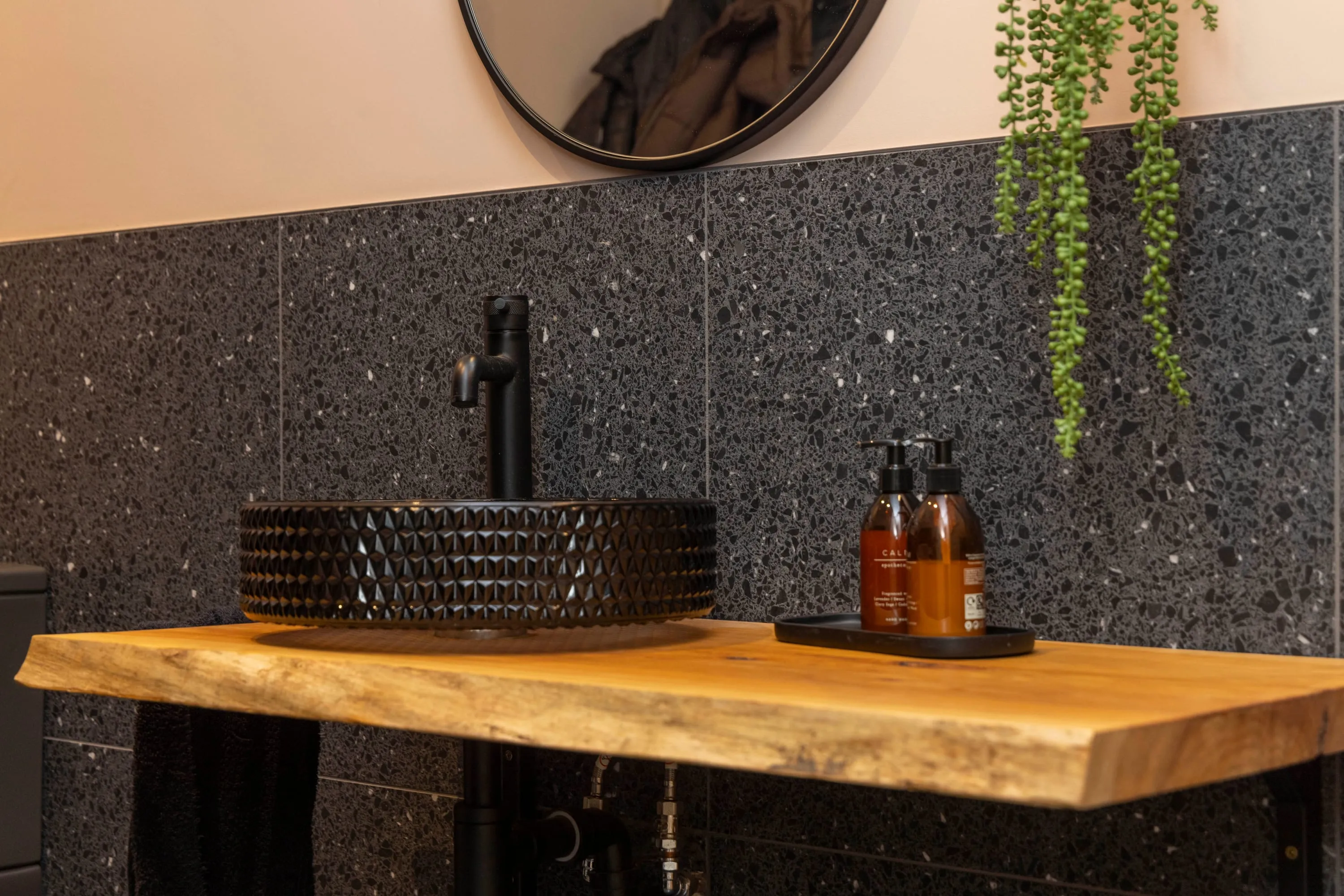 Black basin on a live-edge oak shelf