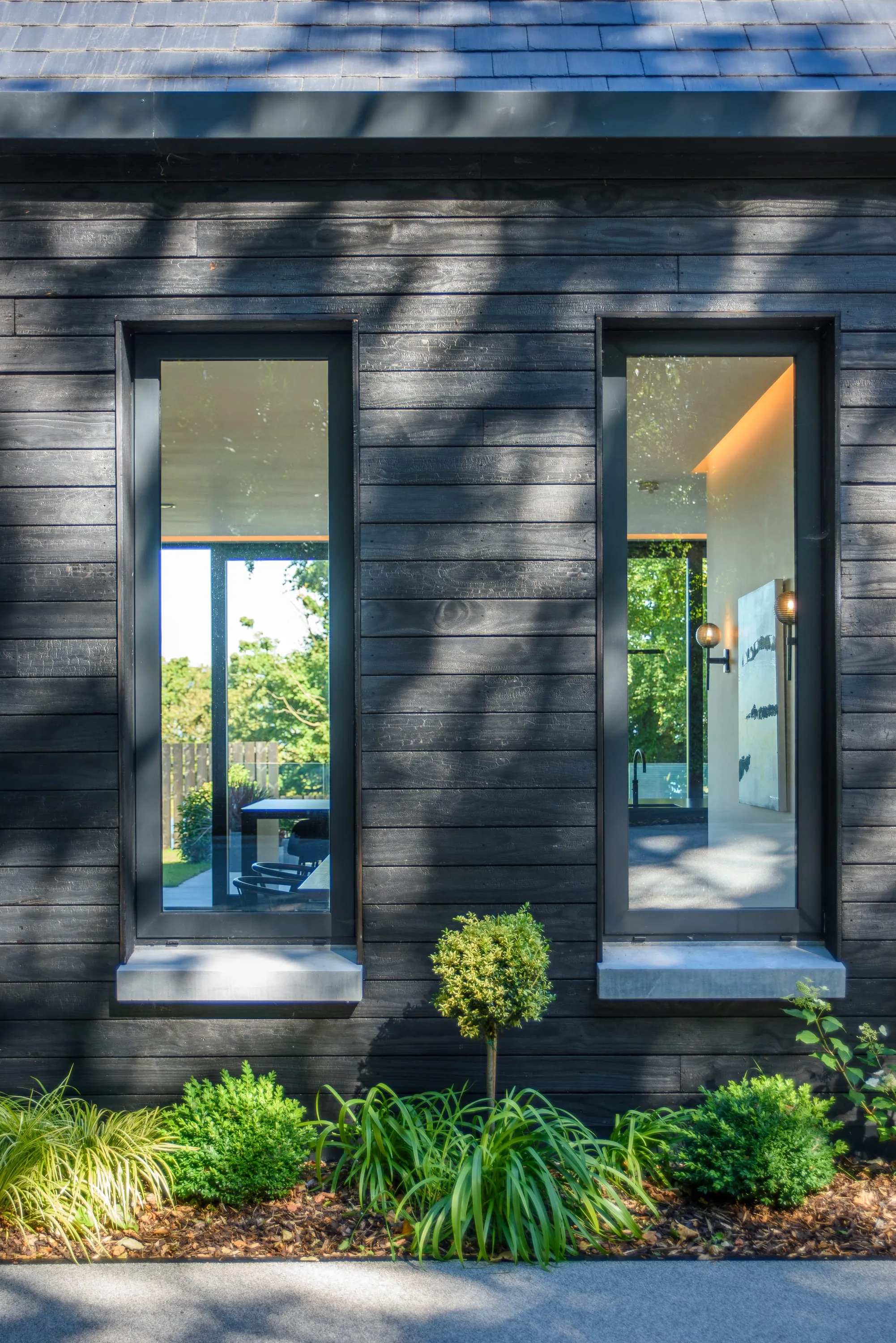 Tall window on the front elevation with planting beneath