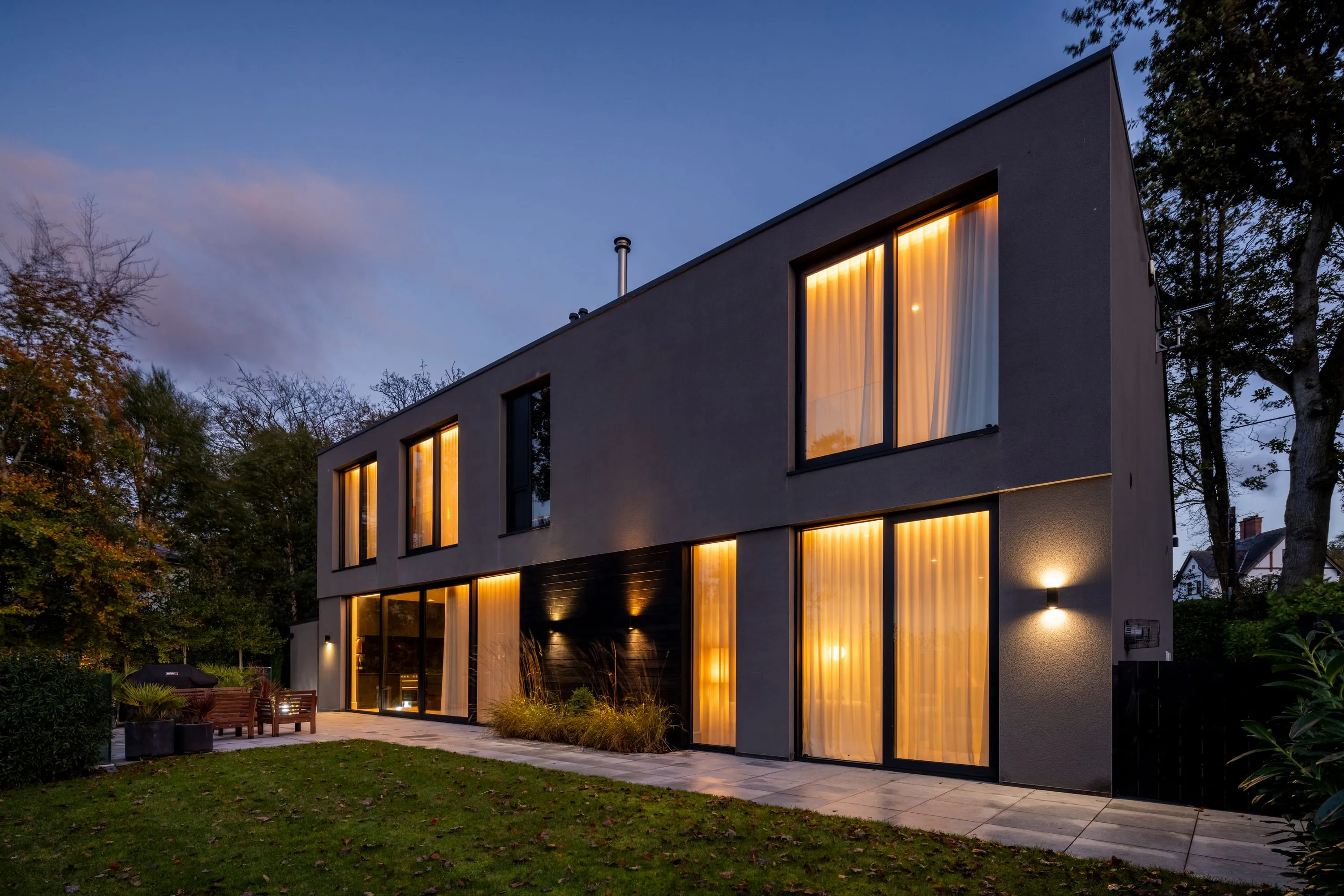 Rear elevation at dusk with every window lit