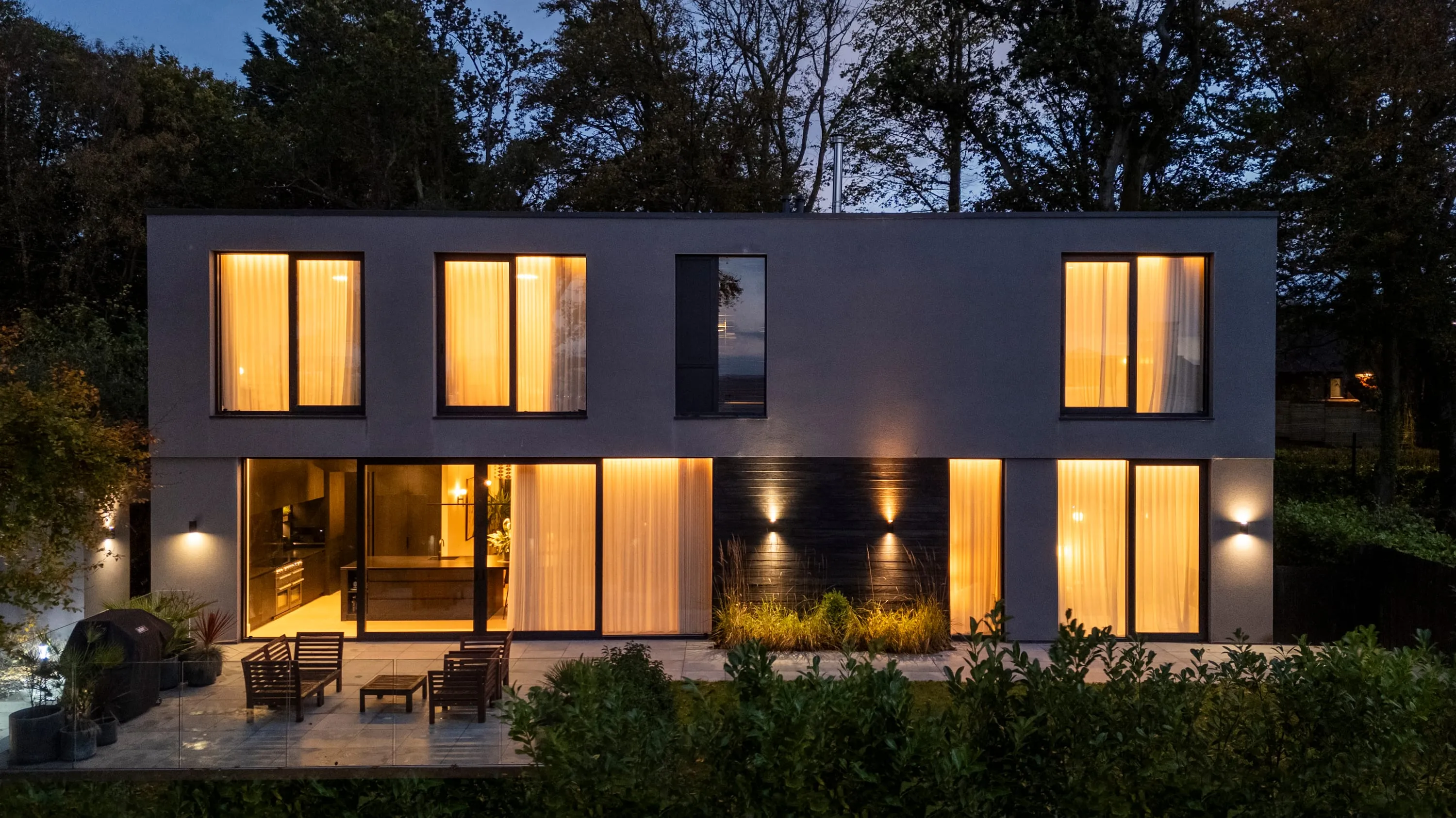 Night view of the rear of the house and terrace lit up