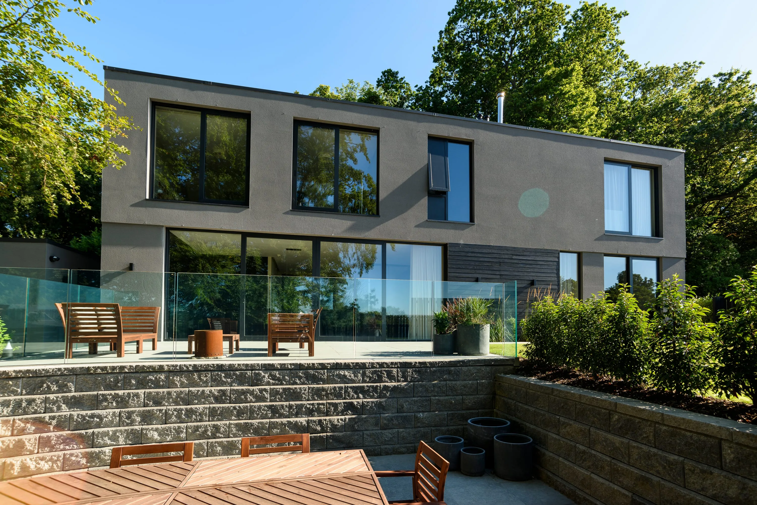 Rear elevation from the lawn with the terrace and outdoor dining table