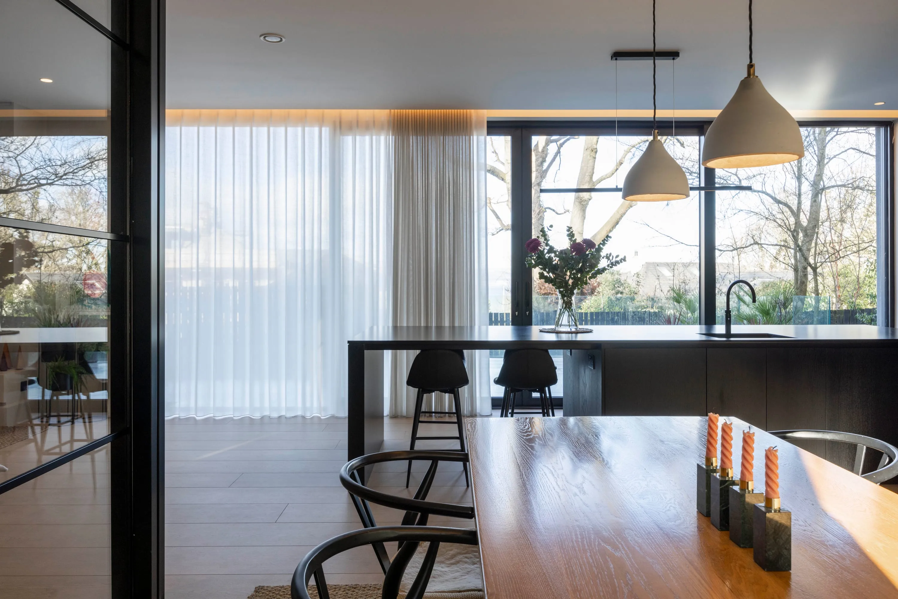 Kitchen island and dining table with garden view