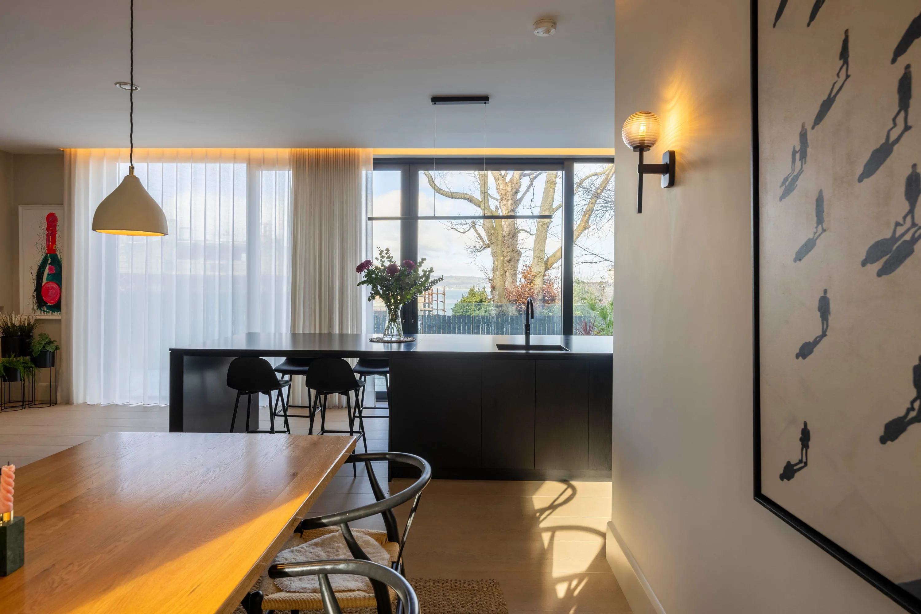 Kitchen island with the lough and trees framed in the window