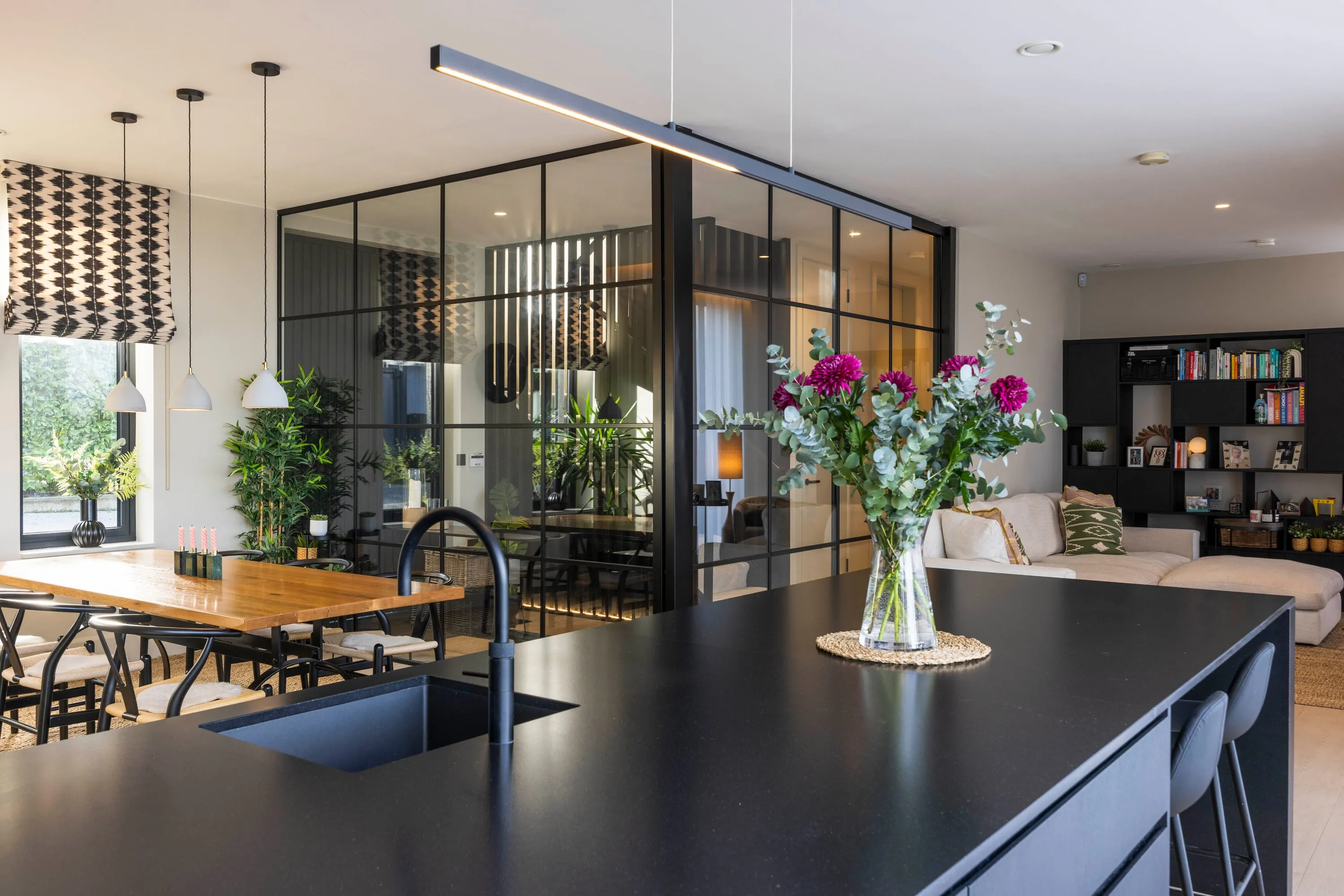 Kitchen island with sink and dining table beyond