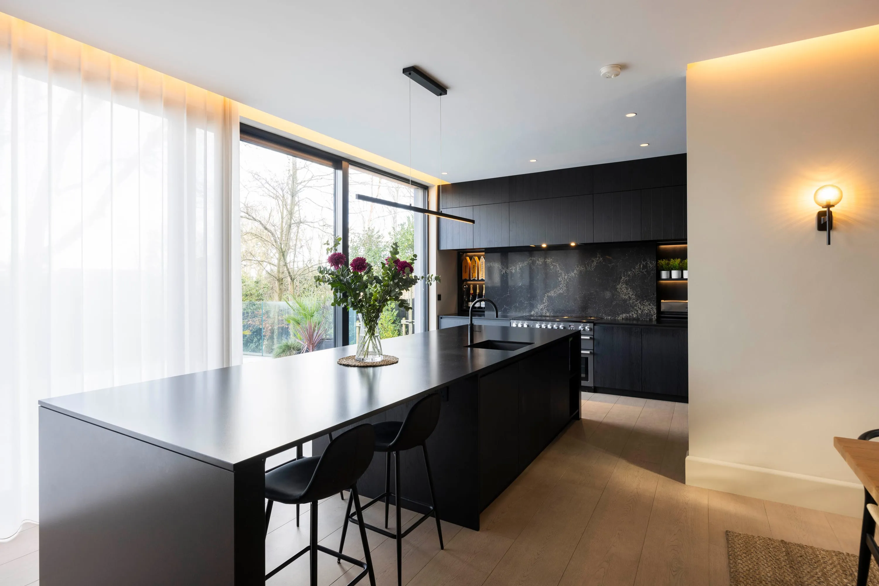 Kitchen with island seating and sheer curtains