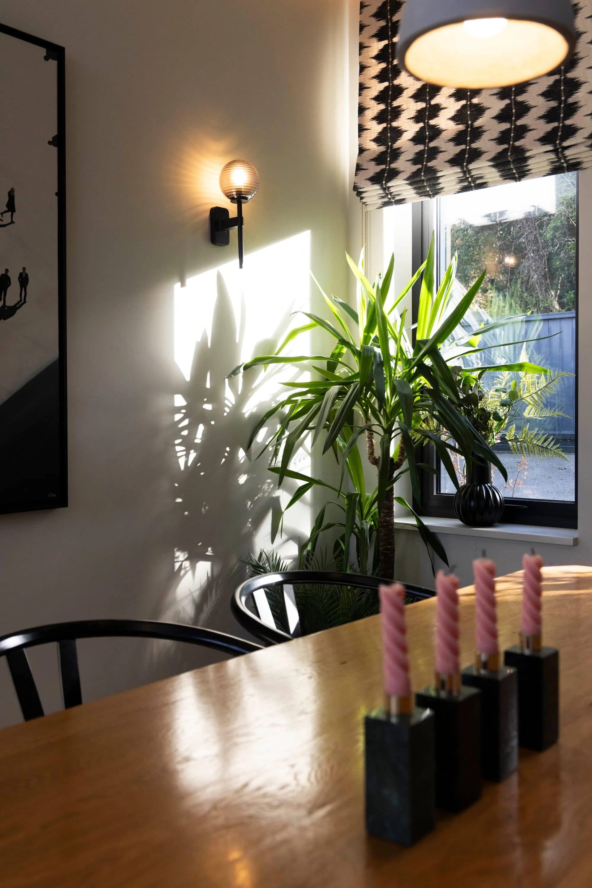 Dining table, candles and wall light