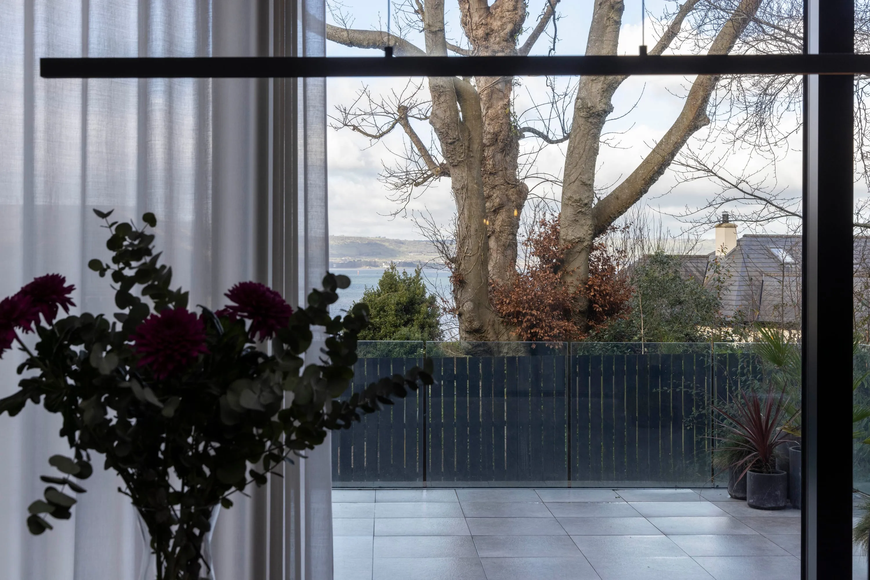 View from the kitchen across the terrace to the trees