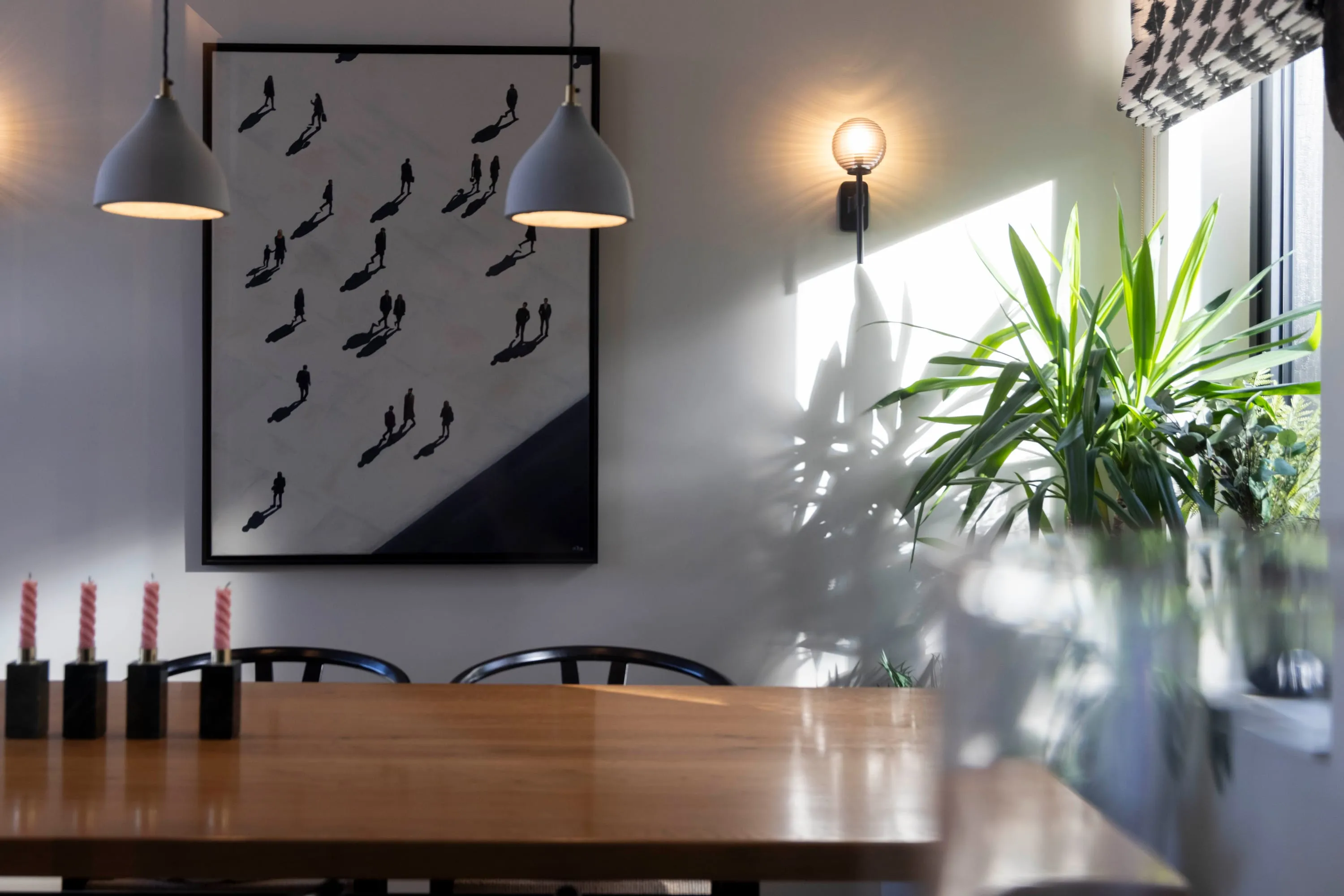 Dining area with pendant lights and artwork