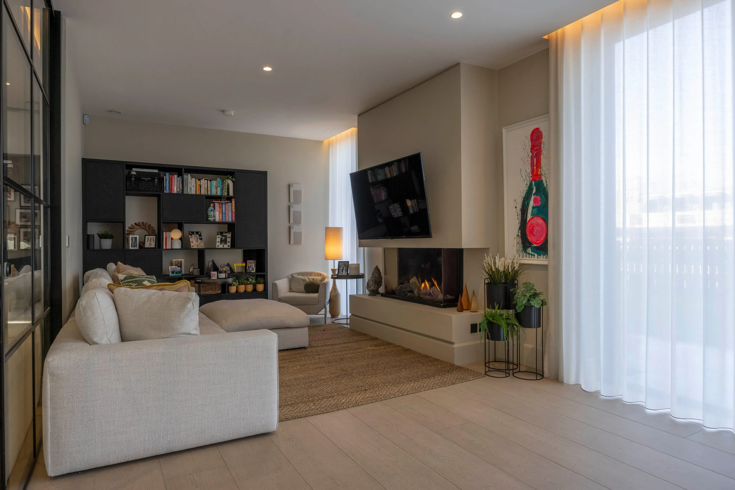 Living area with sheer curtains and fireplace
