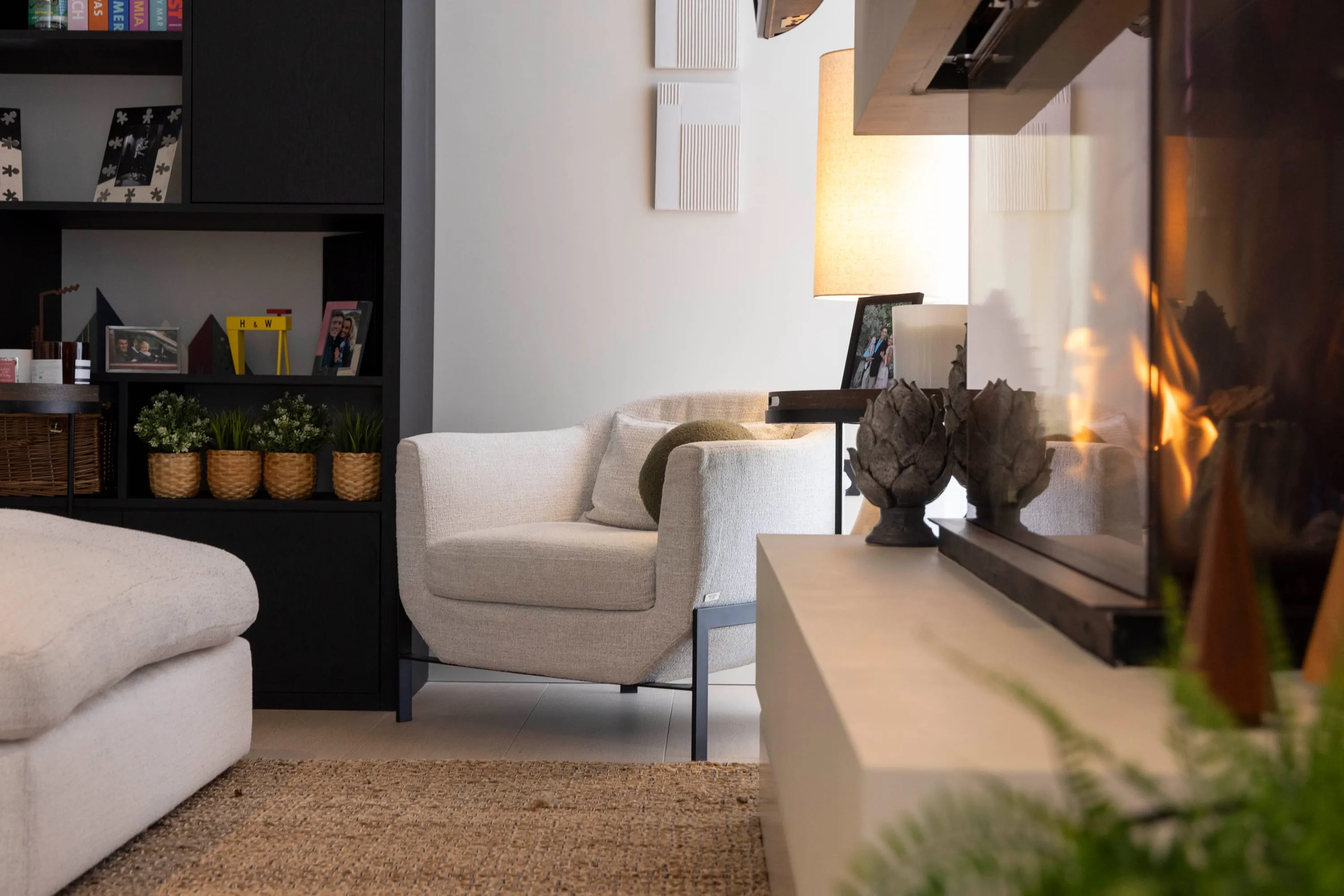 Black shelving and armchair in the living area