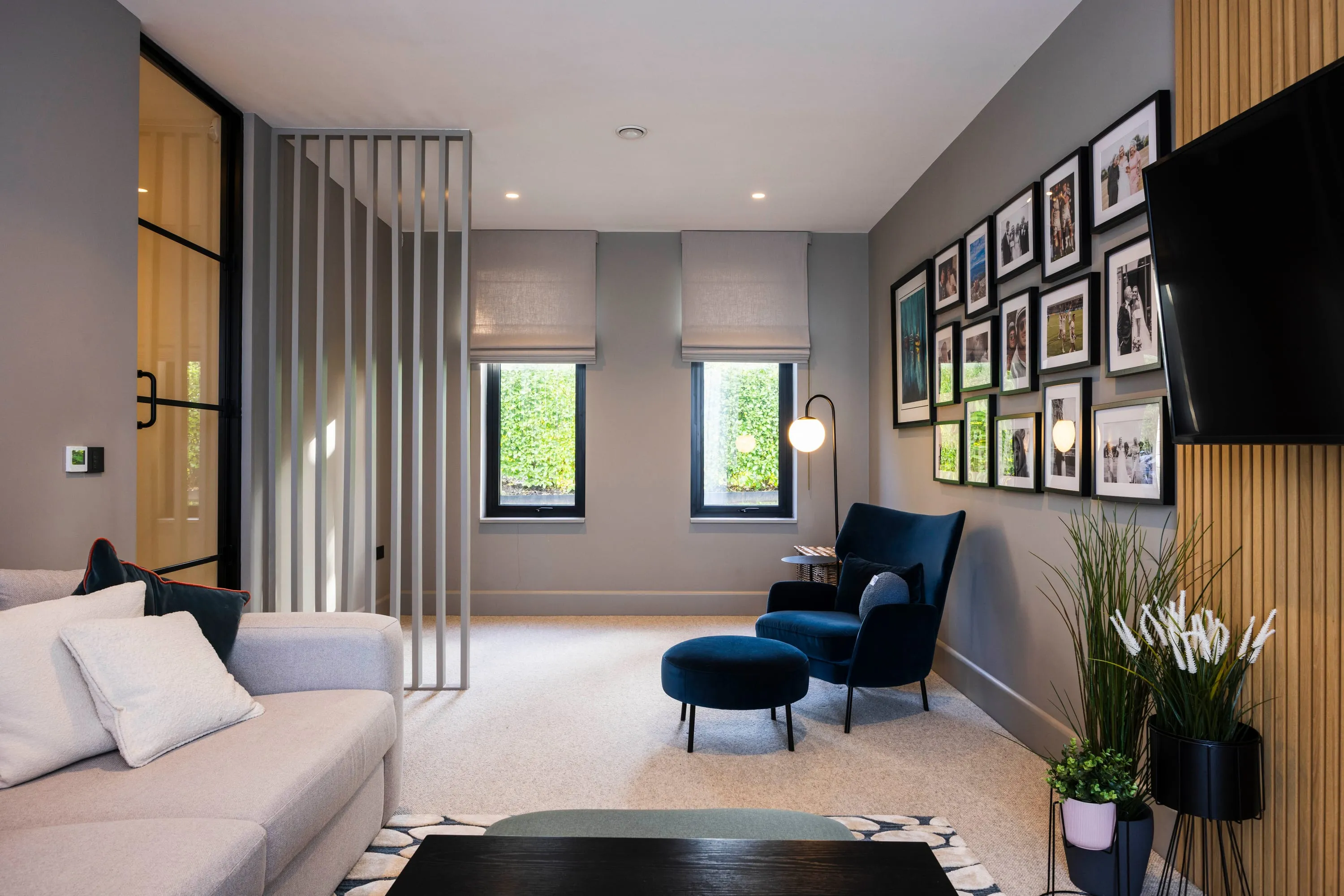 Lounge with slatted timber screen and gallery wall