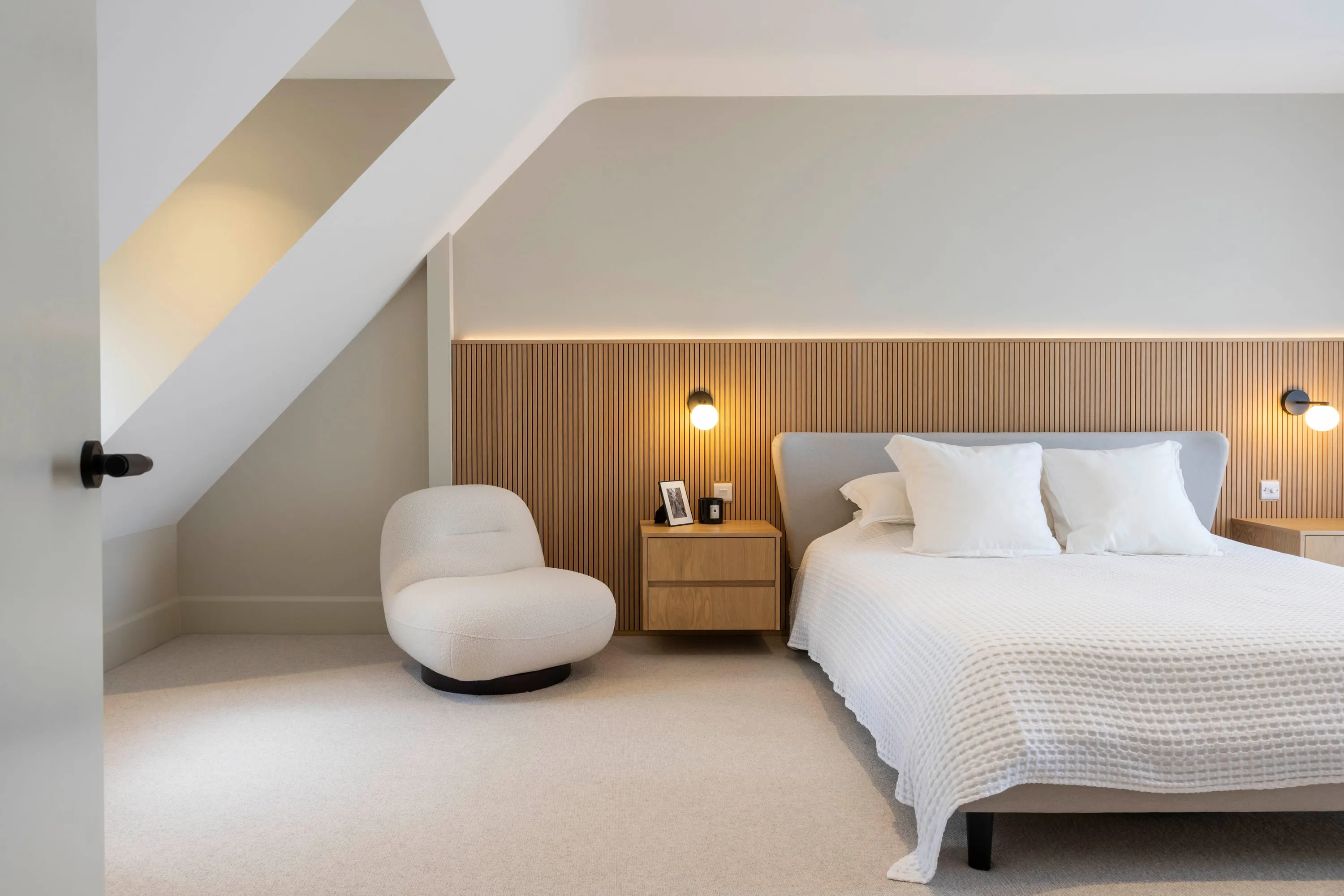 Principal bedroom with slatted oak headboard wall