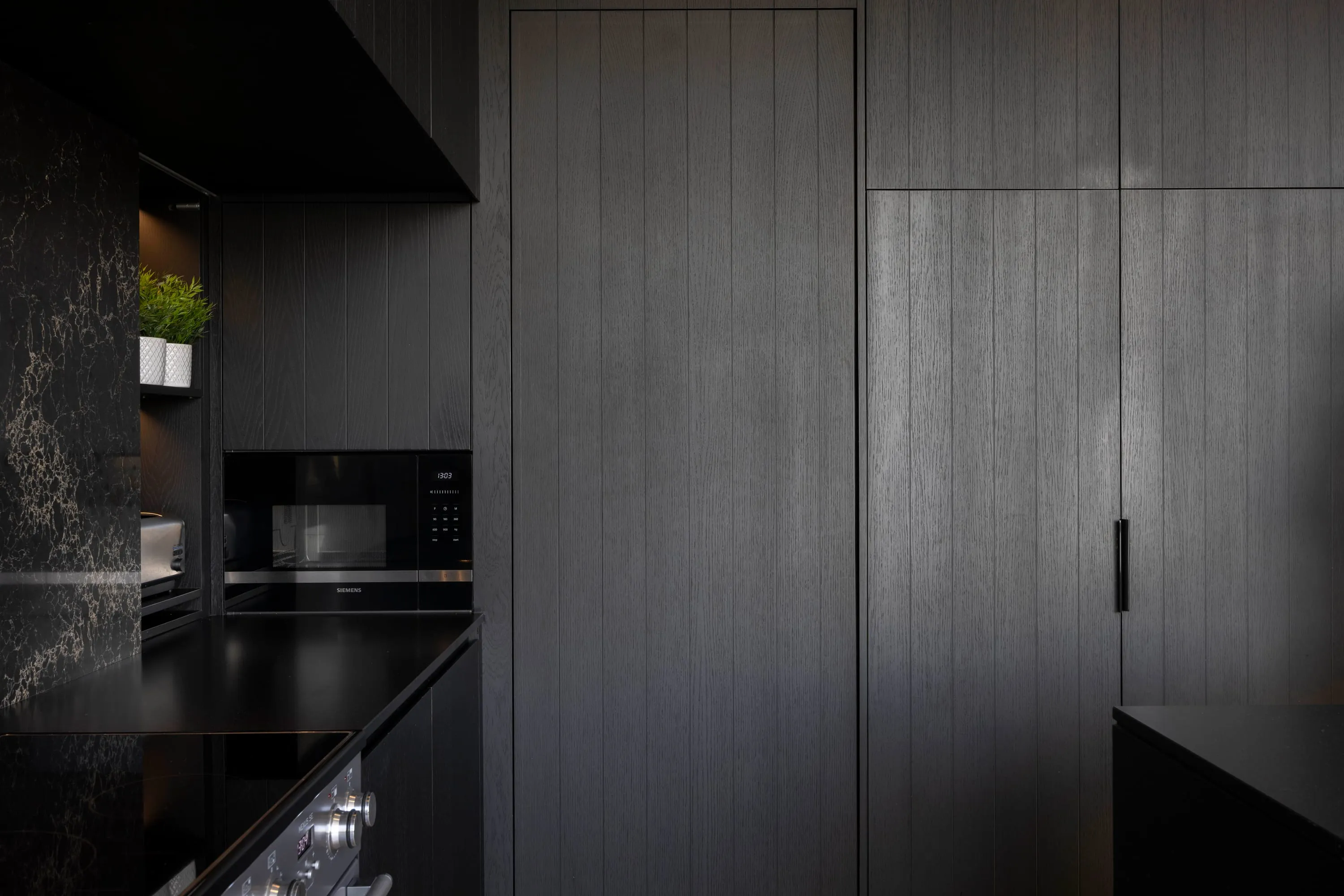 Dark cabinetry in the utility room